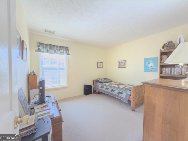 carpeted bedroom featuring a textured ceiling