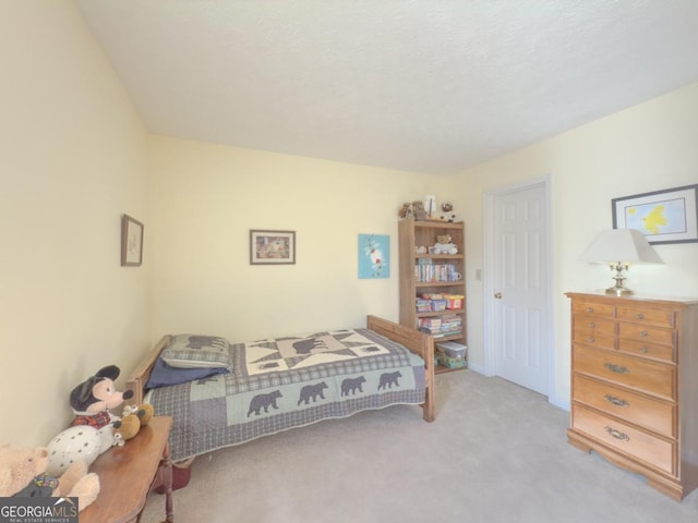 carpeted bedroom featuring a textured ceiling