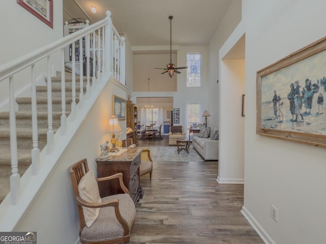 interior space with an inviting chandelier, a high ceiling, and dark hardwood / wood-style flooring