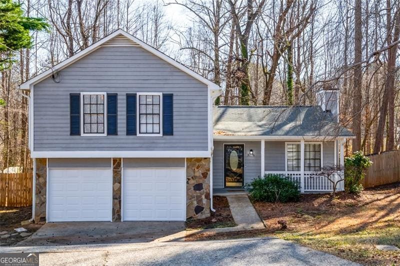 tri-level home with a garage and covered porch