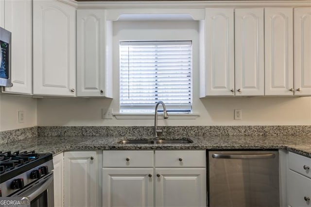 kitchen with white cabinetry, stainless steel appliances, and sink