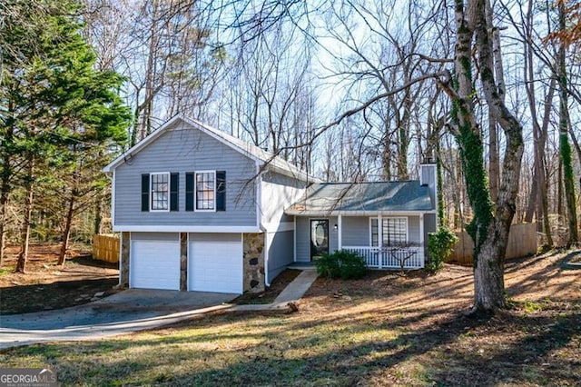 tri-level home with a garage and a porch