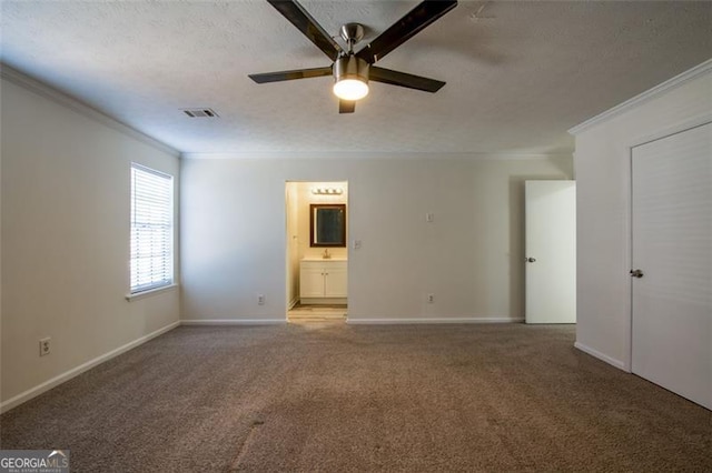 carpeted empty room with ceiling fan, ornamental molding, sink, and a textured ceiling