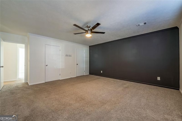 empty room with light carpet and ceiling fan