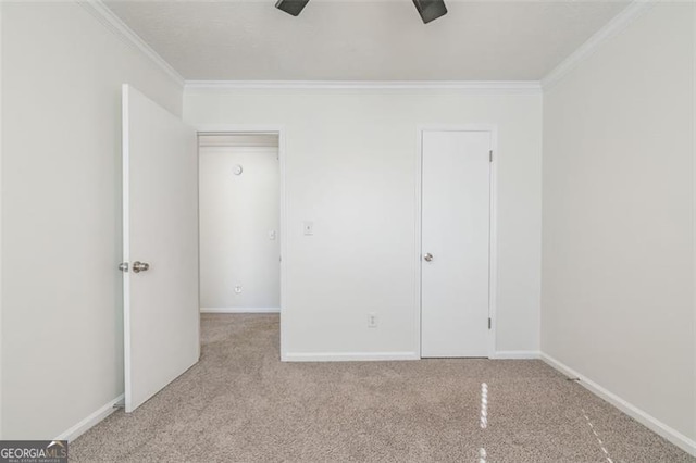 unfurnished bedroom featuring crown molding, light colored carpet, and ceiling fan