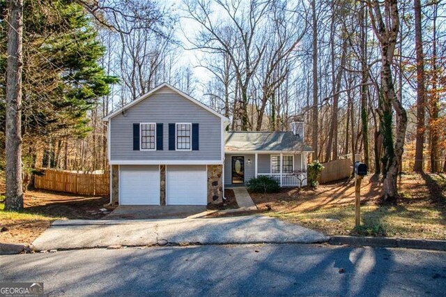 tri-level home with a garage and covered porch