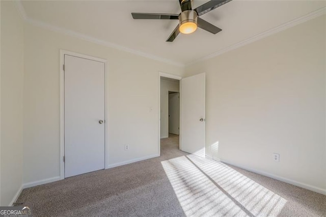 unfurnished bedroom featuring crown molding, light colored carpet, and ceiling fan