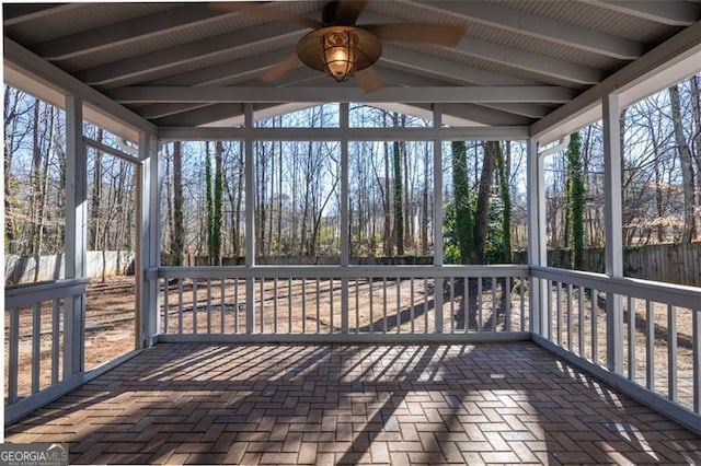 unfurnished sunroom featuring vaulted ceiling