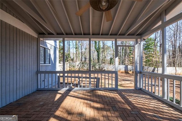 unfurnished sunroom featuring lofted ceiling and plenty of natural light