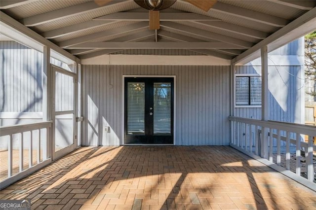 unfurnished sunroom with lofted ceiling and french doors