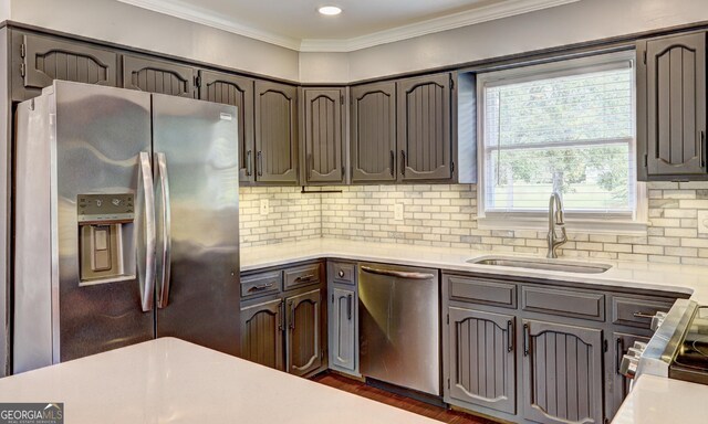 kitchen with stainless steel appliances, sink, decorative backsplash, and plenty of natural light