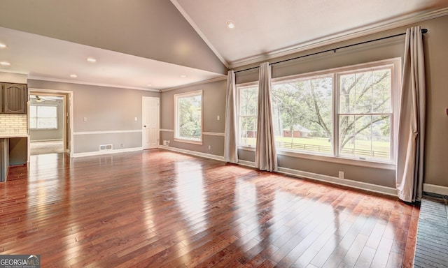 unfurnished living room featuring crown molding, high vaulted ceiling, and hardwood / wood-style floors