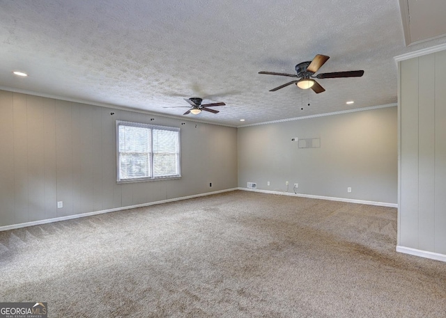 carpeted empty room with ceiling fan, crown molding, and a textured ceiling