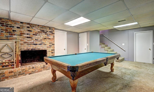 playroom with a brick fireplace, carpet flooring, pool table, and a drop ceiling