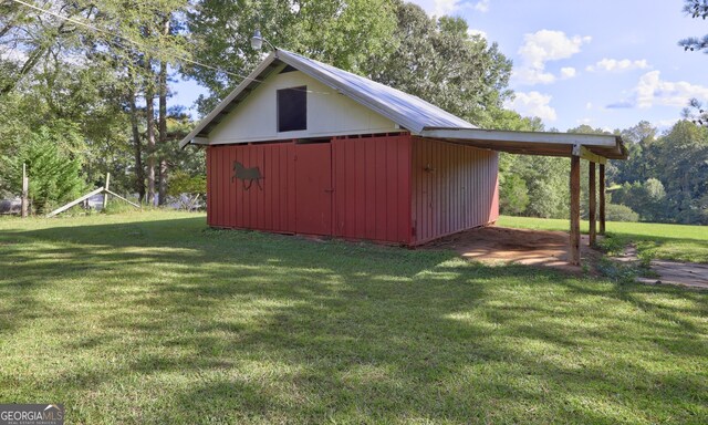 view of outdoor structure featuring a lawn