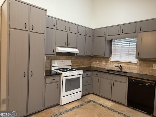 kitchen featuring white gas range, black dishwasher, sink, gray cabinetry, and light tile patterned floors