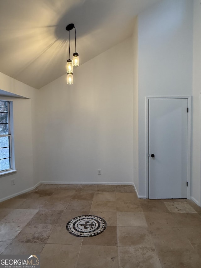 unfurnished room with lofted ceiling