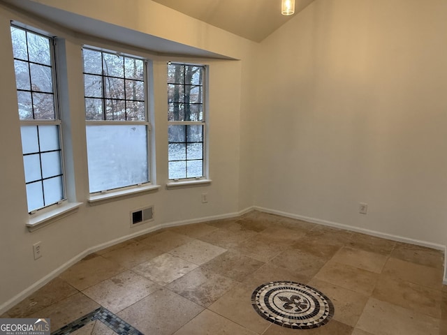 unfurnished room featuring plenty of natural light