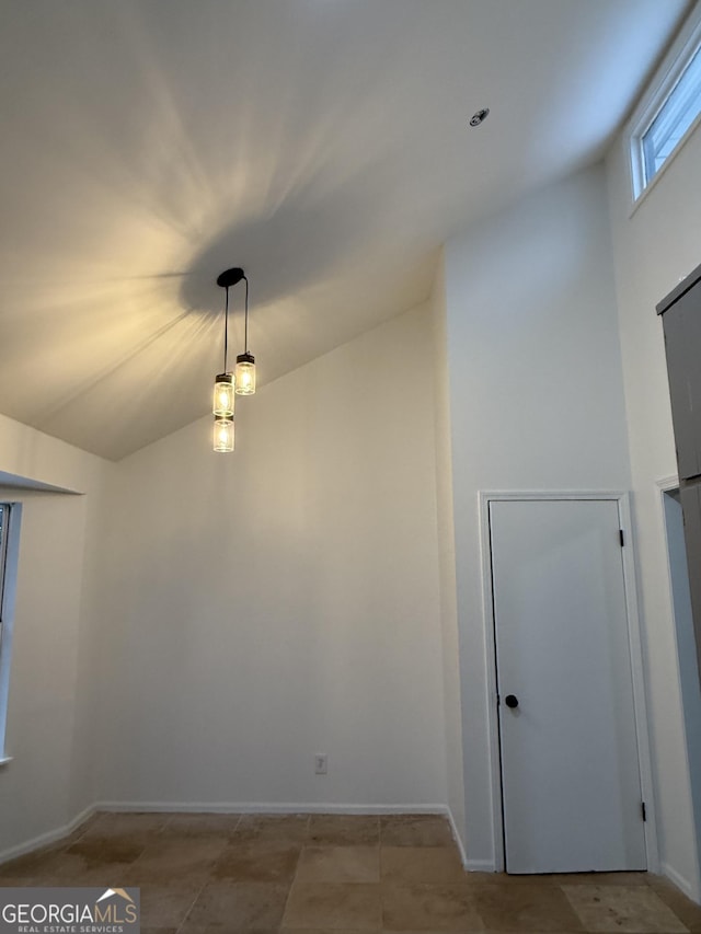 empty room featuring lofted ceiling