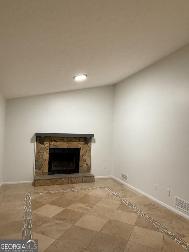 unfurnished living room with a stone fireplace