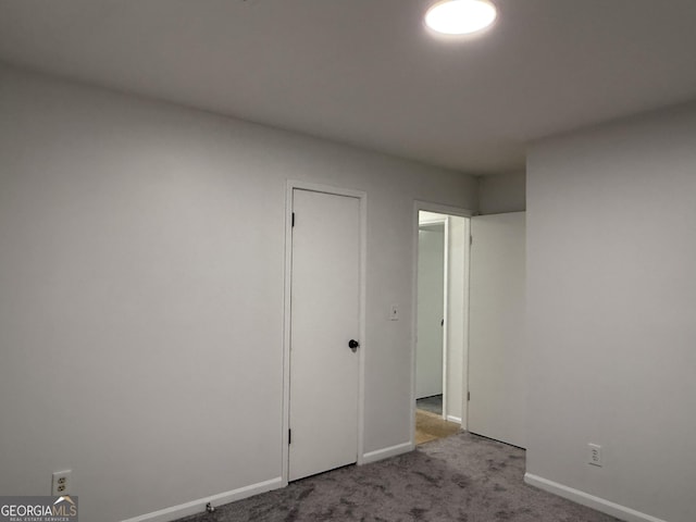 unfurnished bedroom featuring light carpet