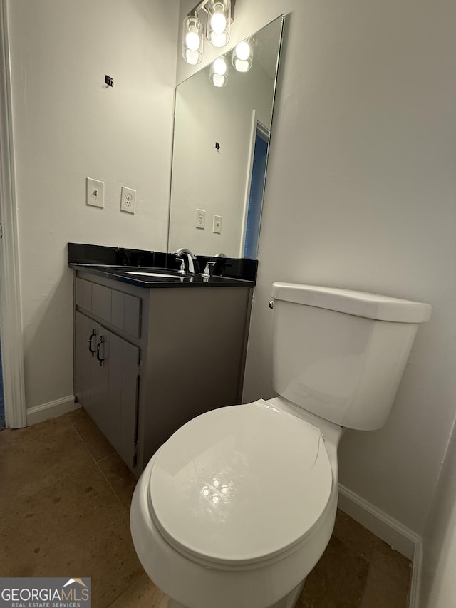 bathroom featuring vanity, tile patterned flooring, and toilet