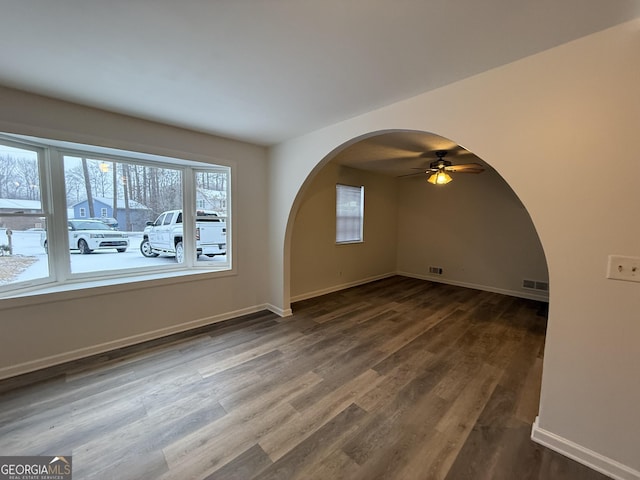 interior space with dark hardwood / wood-style flooring, a wealth of natural light, and ceiling fan