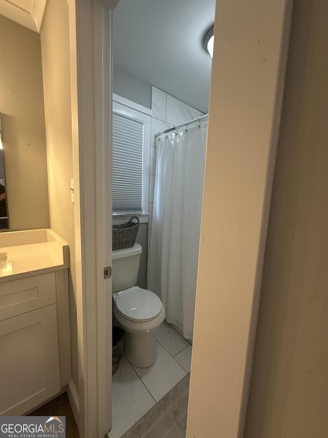 bathroom with vanity, toilet, and tile patterned flooring