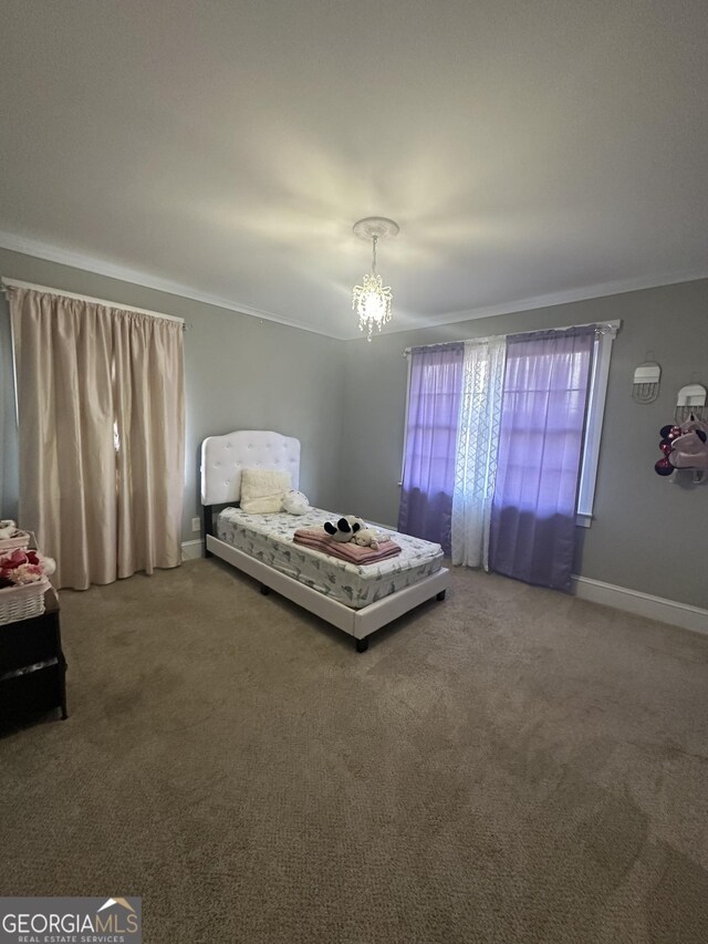 carpeted bedroom with ornamental molding and a notable chandelier