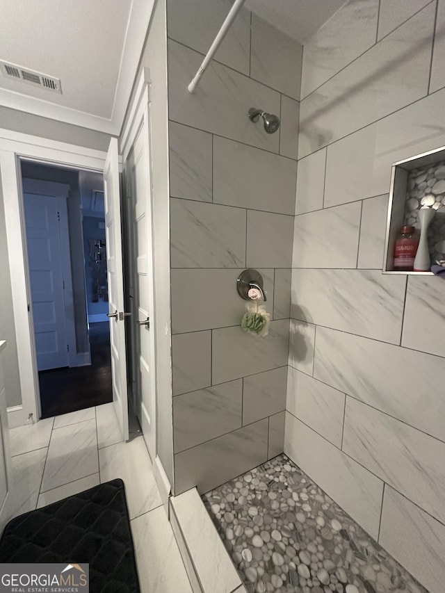 bathroom with tiled shower