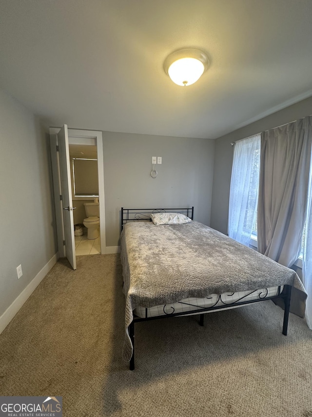 bedroom featuring carpet and connected bathroom