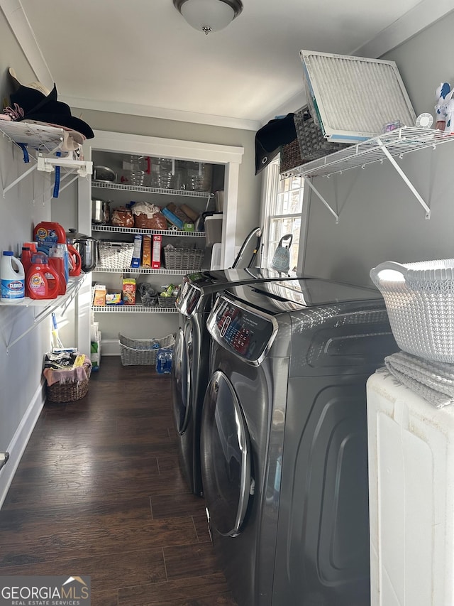 laundry area featuring dark wood-type flooring, ornamental molding, and independent washer and dryer