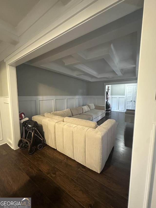 living room with dark hardwood / wood-style flooring, beam ceiling, and coffered ceiling