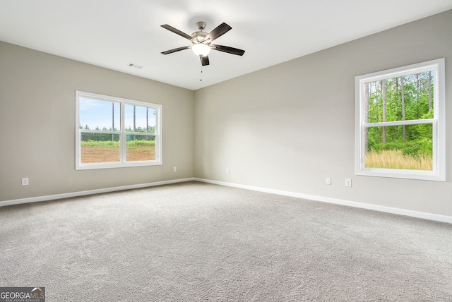 empty room featuring ceiling fan and carpet flooring