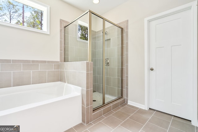 bathroom featuring independent shower and bath and tile patterned floors