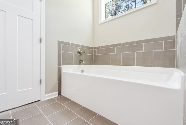 bathroom with tile patterned floors and a bathing tub