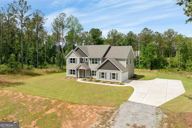 craftsman inspired home featuring a garage and a front lawn