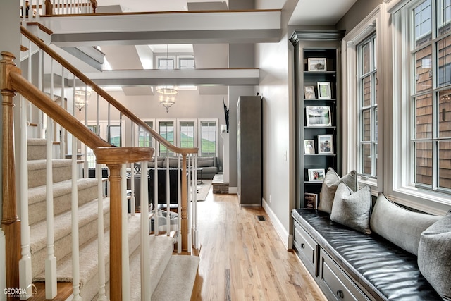 interior space with light wood-type flooring and a chandelier