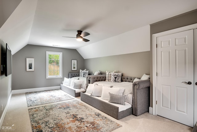 carpeted bedroom featuring ceiling fan and vaulted ceiling