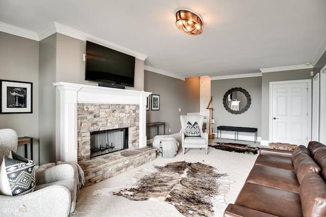 carpeted living room with ornamental molding and a stone fireplace