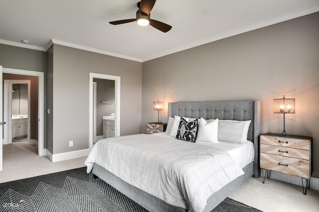 carpeted bedroom with ceiling fan, ensuite bathroom, and ornamental molding