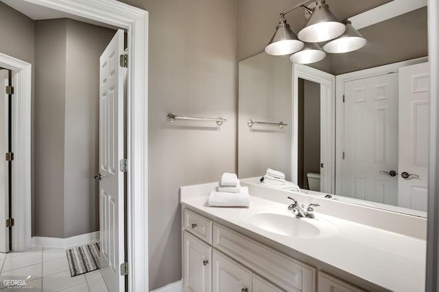 bathroom featuring tile patterned floors, vanity, and toilet