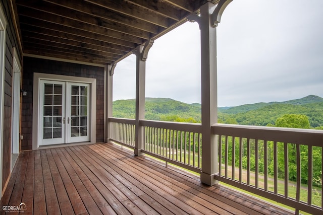 wooden terrace featuring a mountain view and french doors