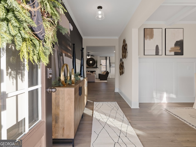 entrance foyer with crown molding, dark wood-type flooring, and ceiling fan