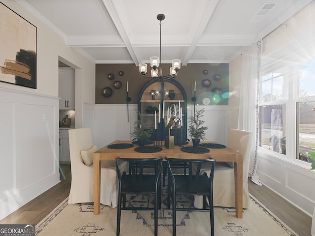 dining room with coffered ceiling, a notable chandelier, beam ceiling, and light hardwood / wood-style flooring