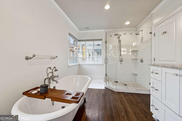 bathroom with hardwood / wood-style flooring, crown molding, shower with separate bathtub, and vanity