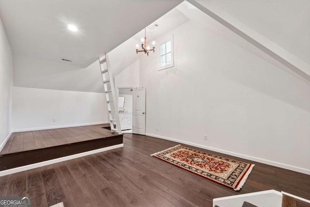 interior space featuring lofted ceiling, a chandelier, and dark hardwood / wood-style flooring