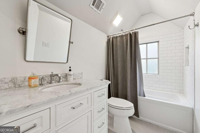 full bathroom featuring vaulted ceiling, shower / bath combination with curtain, tile patterned flooring, vanity, and toilet