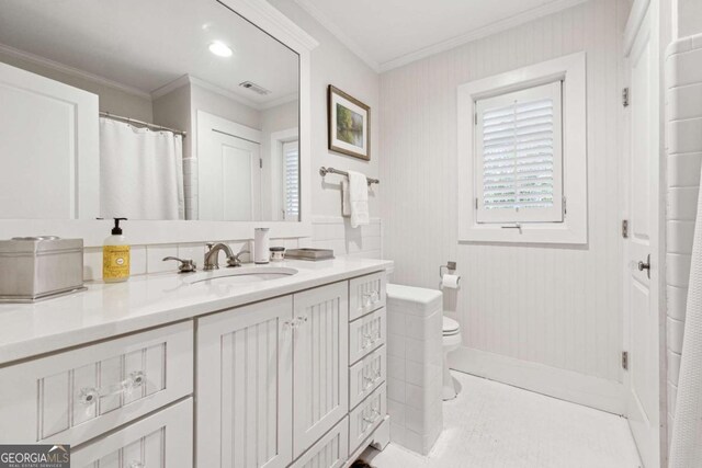 bathroom with crown molding, tile patterned floors, toilet, and vanity