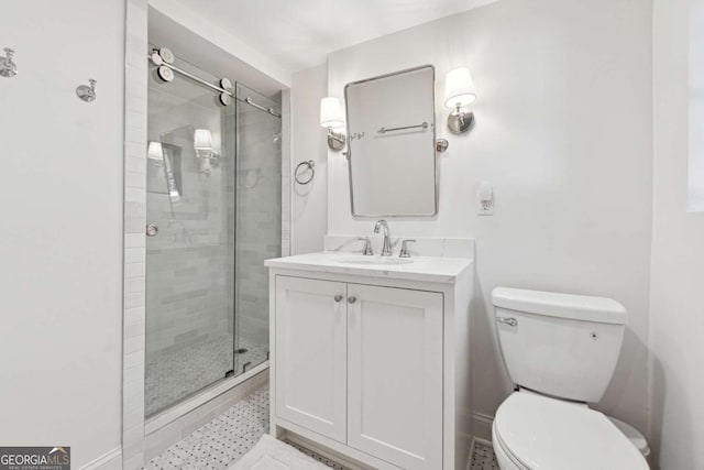 bathroom featuring vanity, toilet, and a shower with door